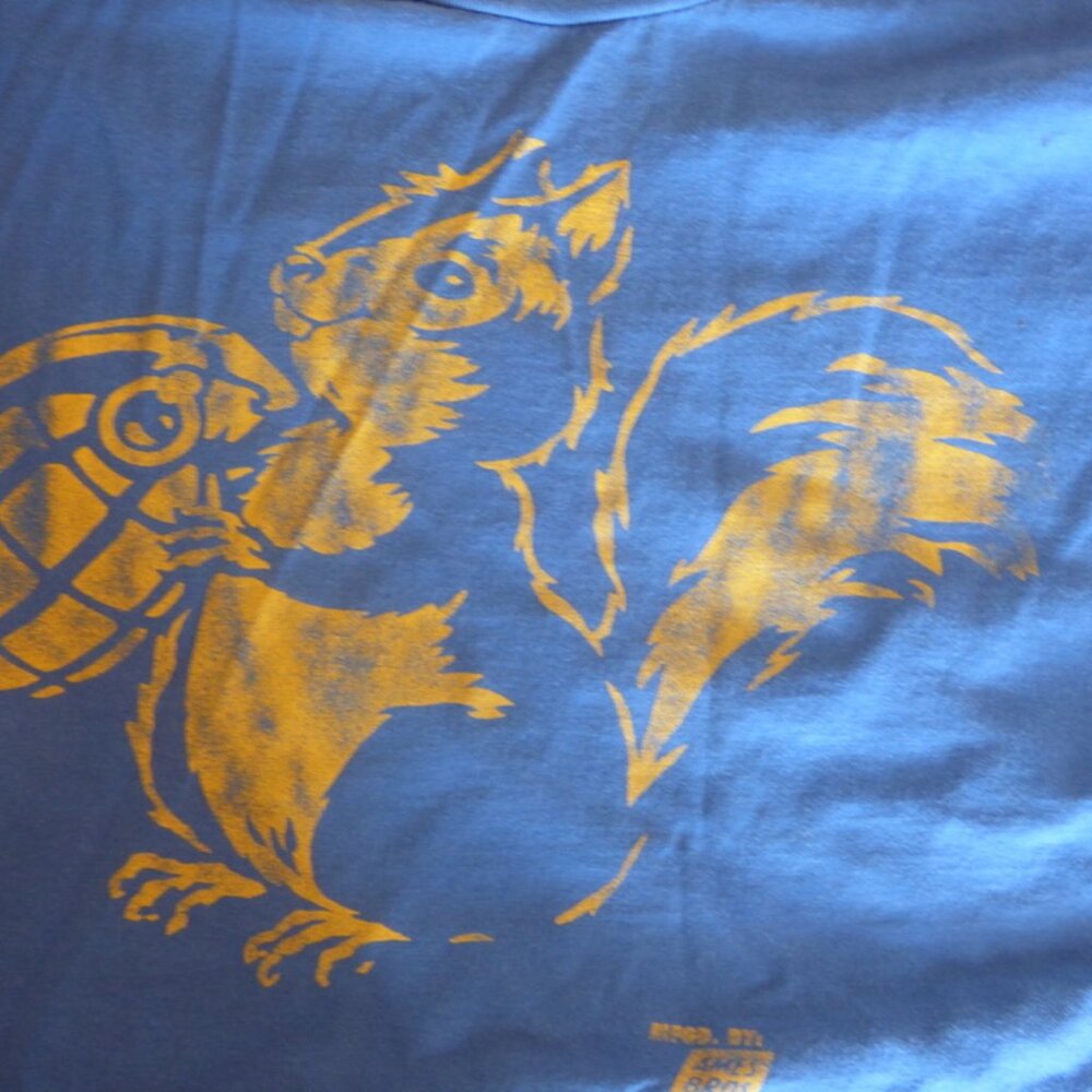 Tee-shirt with a squirell holding a hand gernade which he believes is a very lar